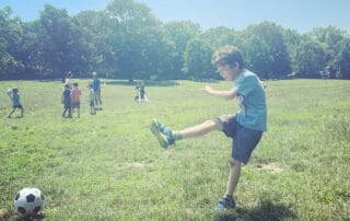 Child kicking soccer ball